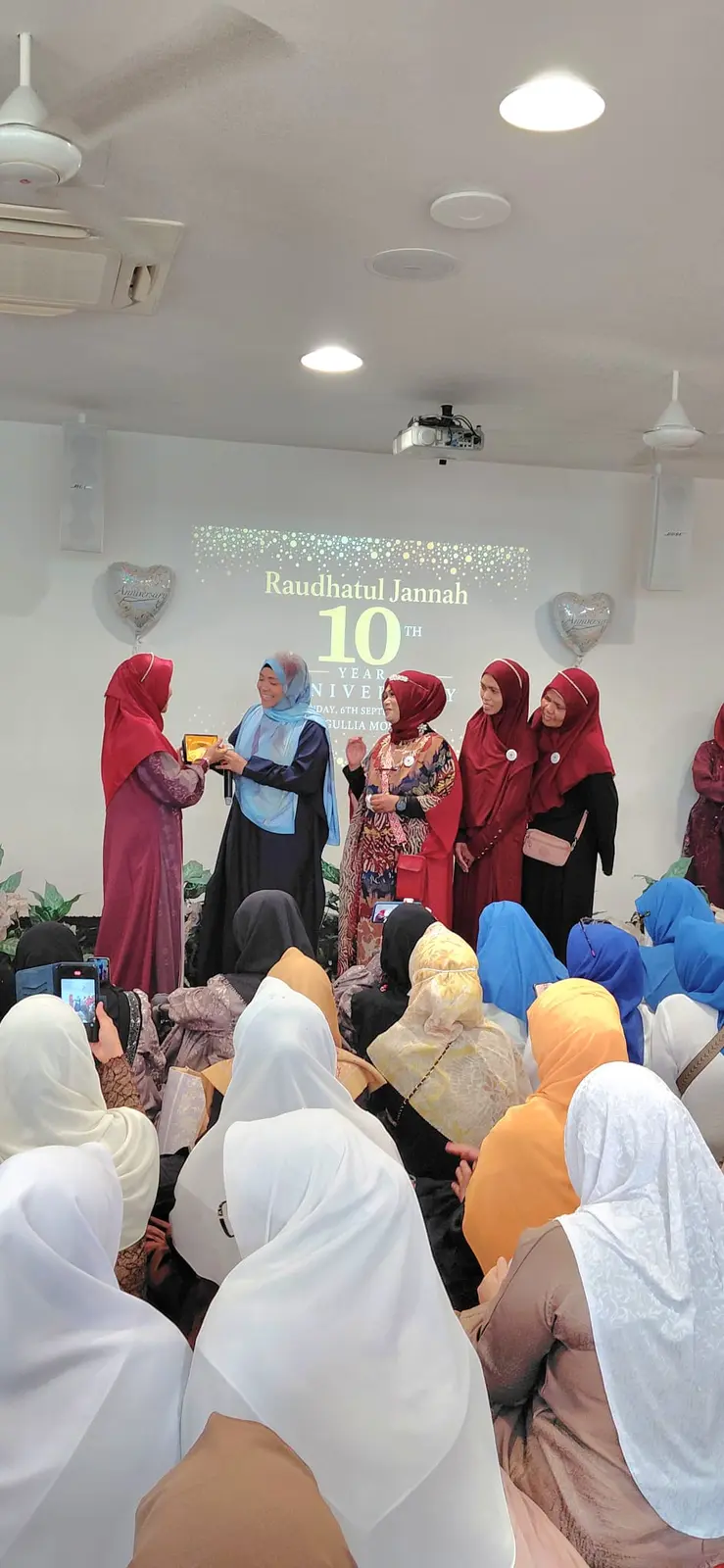 A commemorative plaque being presented during Raudhatul Jannah’s tenth-anniversary gathering