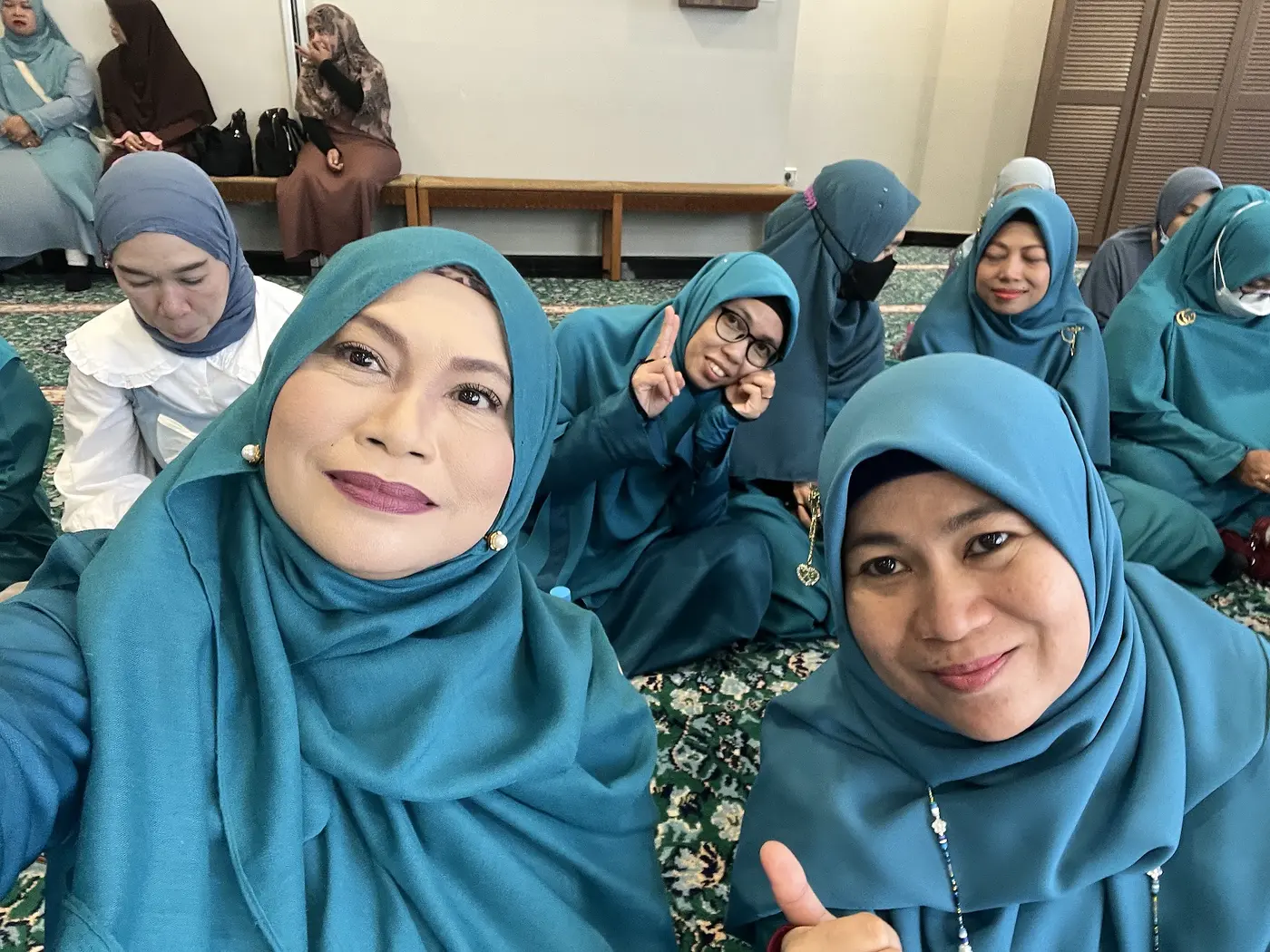 Raudhatul Jannah friends smiling together during a community gathering